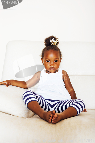 Image of little pretty african american girl sitting in white chair weari