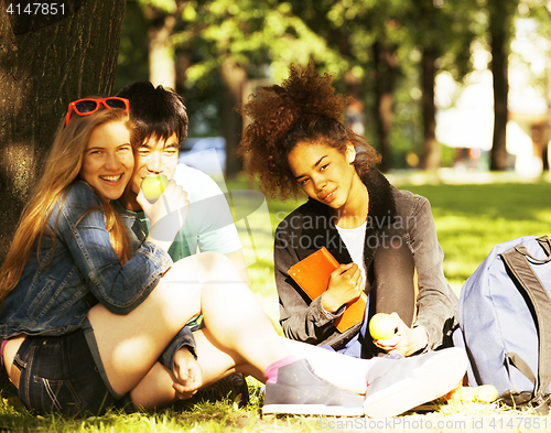 Image of cute group of teenages at the building of university with books 