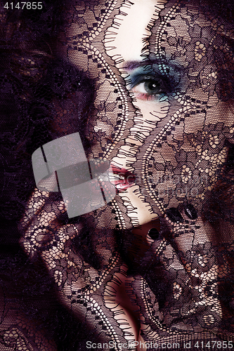 Image of portrait of beauty young woman through lace close up mistery mak