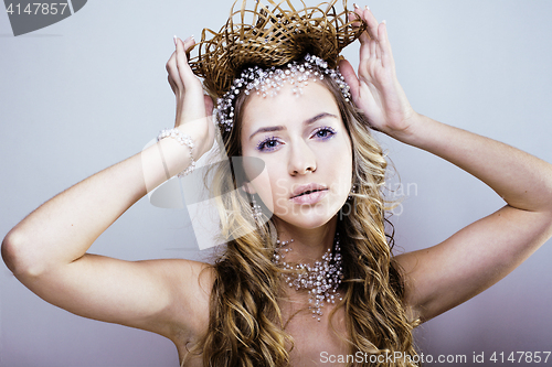 Image of beauty young snow queen with hair crown on her head, complicate 