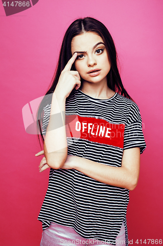 Image of young pretty teenage woman emotional posing on pink background, fashion lifestyle people concept