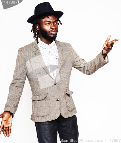 Image of young handsome afro american boy in stylish hipster hat gesturin