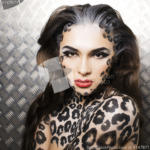 Image of young sexy woman with leopard make up all over body, cat bodyart