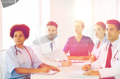 Image of group of happy doctors on conference at hospital