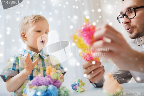 Image of father and son playing with ball clay at home