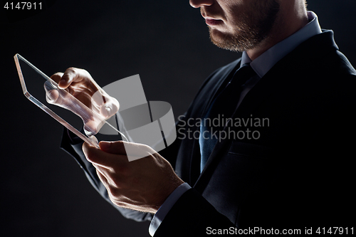 Image of close up of businessman with transparent tablet pc