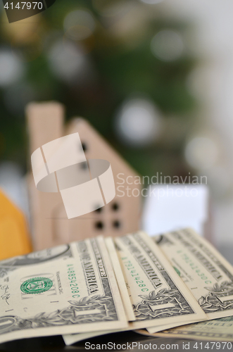 Image of Miniature paper made house stand on  money