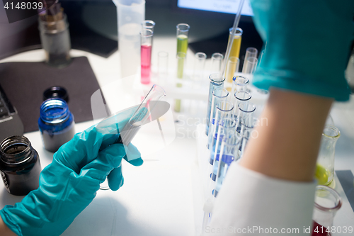 Image of Worker chemical lab with tubes