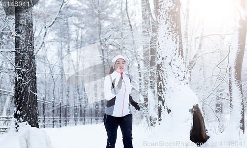 Image of Girl running in winter park