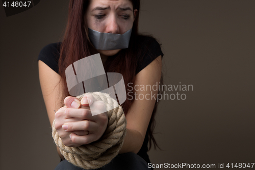 Image of Unhappy woman with sealed mouth