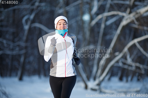 Image of Girl running in winter park