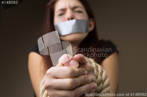 Image of Brunette gagged and tied hands