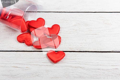 Image of Red hearts on a white wood background