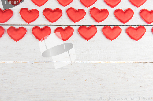 Image of Red hearts on a white wood background