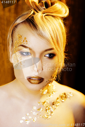 Image of beauty blond woman with gold creative make up