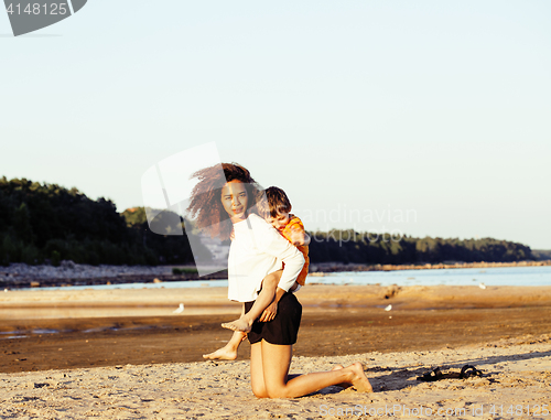 Image of pretty diverse nation and age friends on sea coast having fun, lifestyle people concept on beach vacations