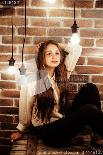 Image of pretty teenage girl having fun in stylish modern loft studio, lifestyle people concept