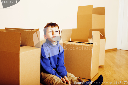 Image of little cute boy in empty room, remoove to new house. home alone, lifestyle people concept