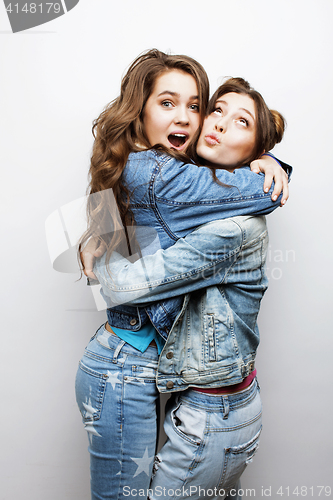 Image of lifestyle and people concept: Fashion portrait of two stylish sexy girls best friends, over white background. Happy time for fun.