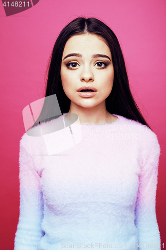 Image of young pretty teenage woman emotional posing on pink background, fashion lifestyle people concept