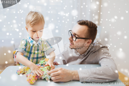 Image of father and son playing with ball clay at home