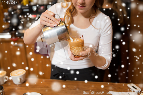 Image of close up of woman making coffee at shop or cafe