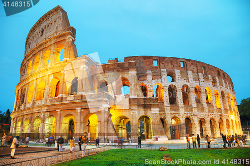 Image of The Colosseum with people at night 