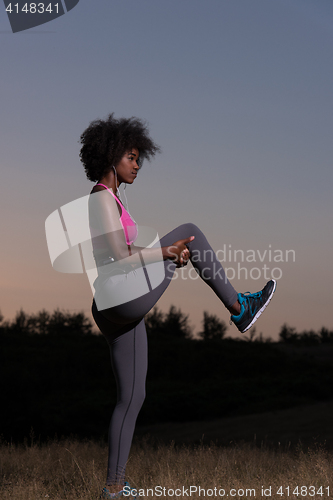 Image of black woman is doing stretching exercise relaxing and warm up