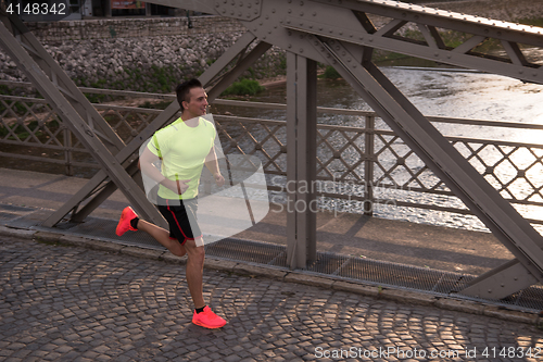 Image of a young man jogging in the city