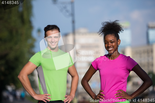 Image of portrait of young multietnic jogging couple ready to run