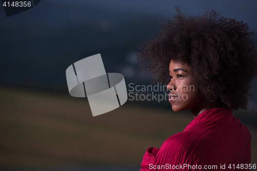 Image of outdoor portrait of a black woman with a scarf