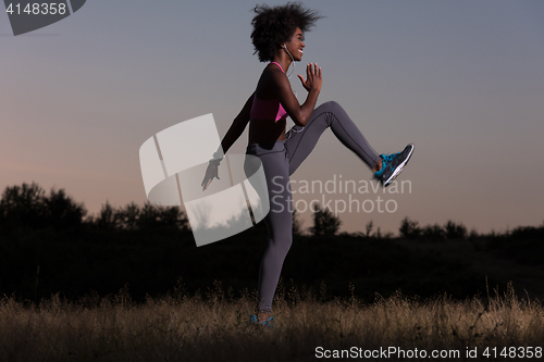 Image of black woman is doing stretching exercise relaxing and warm up