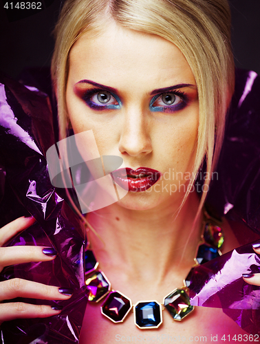 Image of beauty woman with creative make up, many fingers on face 