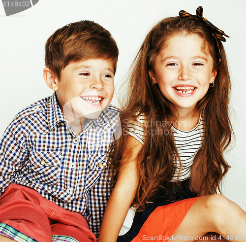 Image of little cute boy and girl hugging playing on white background, happy family smiling