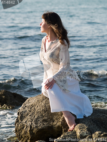 Image of Lady Sitting on Sea Rock