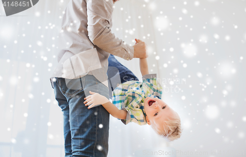 Image of father with son playing and having fun at home