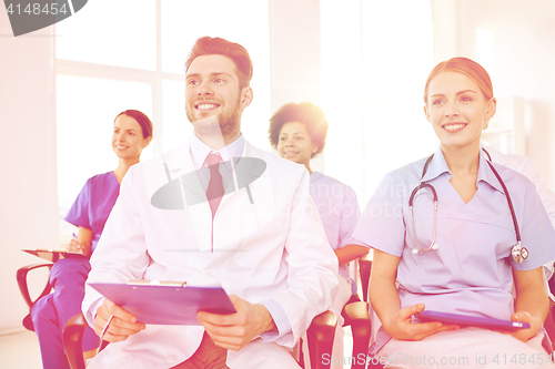 Image of group of happy doctors on seminar at hospital