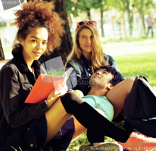 Image of cute group of teenages at the building of university with books 