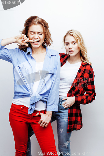 Image of two pretty blond woman having fun together on white background, mature mother and young teenage daughter, lifestyle people concept