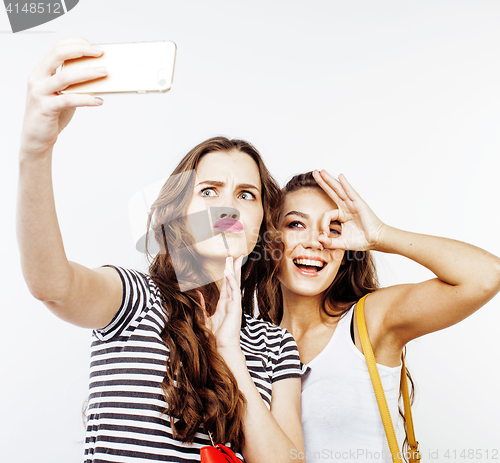 Image of two best friends teenage girls together having fun, posing emotional on white background, besties happy smiling, lifestyle people concept