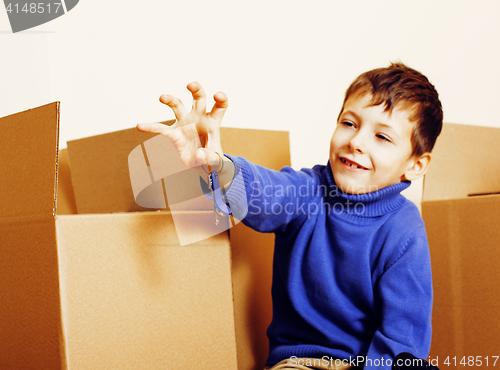 Image of little cute boy in empty room, remoove to new house. home alone, lifestyle people concept