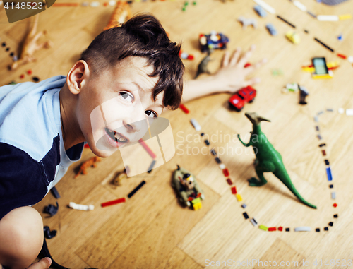 Image of little cute preschooler boy among toys lego at home happy smiling, lifestyle people concept