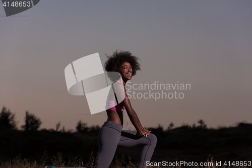 Image of black woman is doing stretching exercise relaxing and warm up