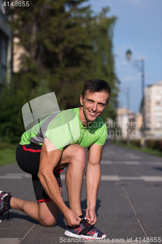 Image of Young athlete, runner tie shoelaces in shoes