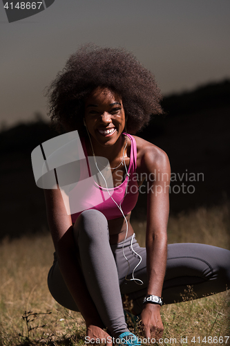 Image of black woman runner tightening shoe lace