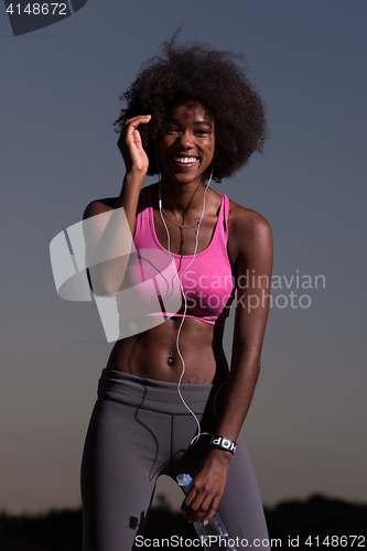 Image of african american woman jogging in nature