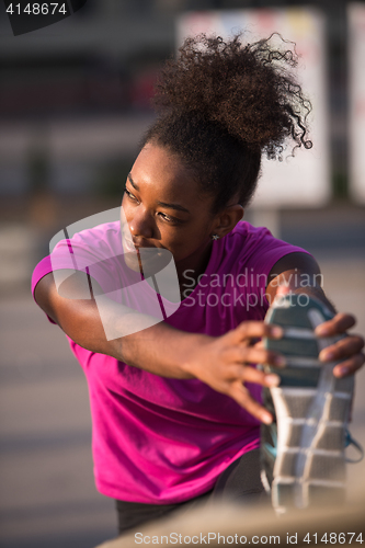 Image of African American woman doing warming up and stretching