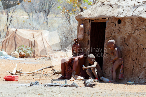 Image of Himba woman with child in the village