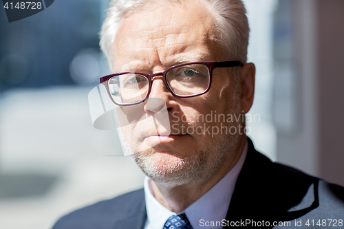 Image of close up of senior businessman in eyeglasses