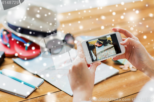 Image of close up of woman with smartphone and travel stuff